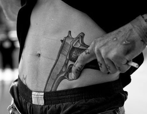 A hason elhelyezett pisztoly tetoválás népszerű, vagány választás